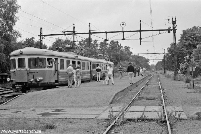 Två elmotorvagnar av littera X16 eller X17 vid plattformen i Fjugesta vid mitten av 1980-talet. - klicka för att stänga rutan